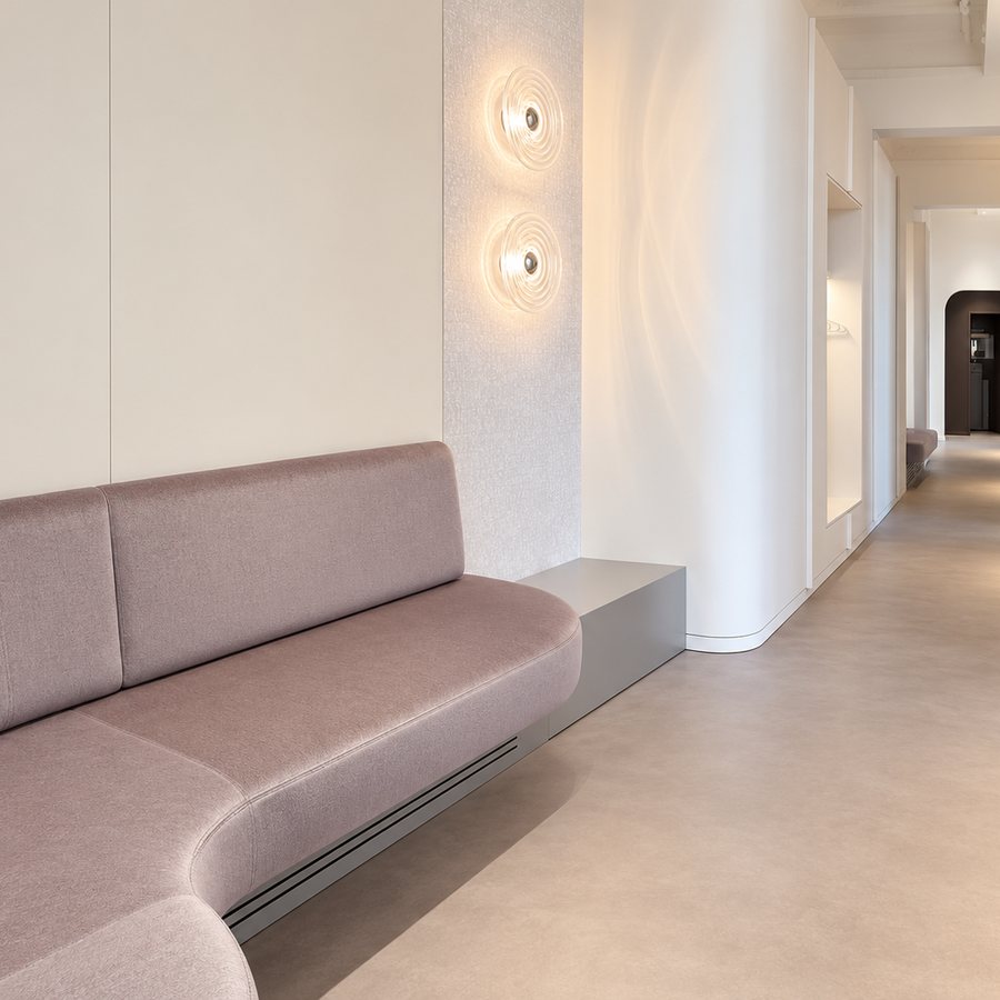 Corridor with bench and wall lights